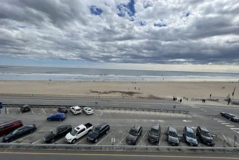 a parking lot filled with lots of parked cars.