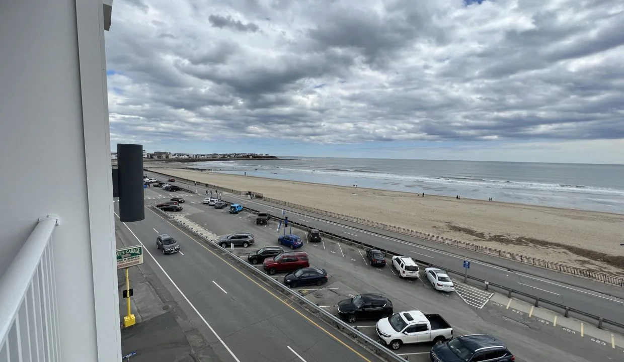 a view of a beach from a balcony of a building.