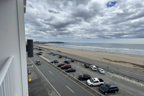 a view of a beach from a balcony of a building.