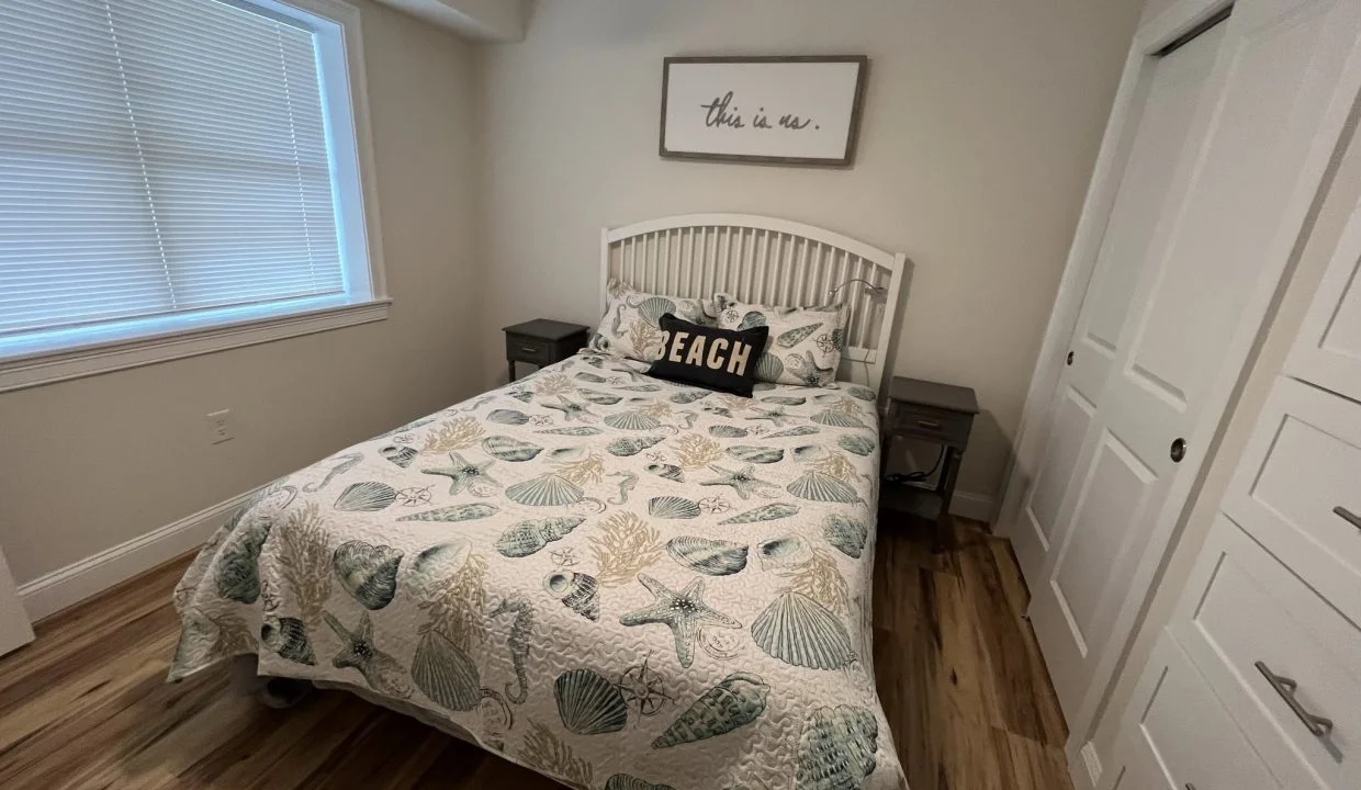 a bed sitting in a bedroom next to a window.