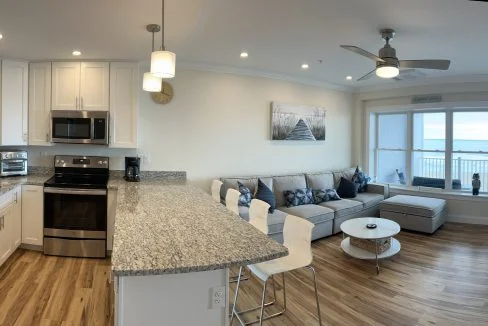 a kitchen and living room with a large window.