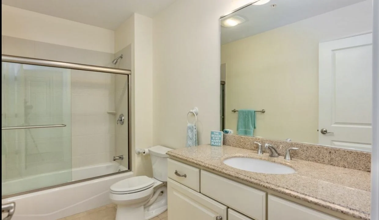 A bathroom with a sink, toilet and shower.