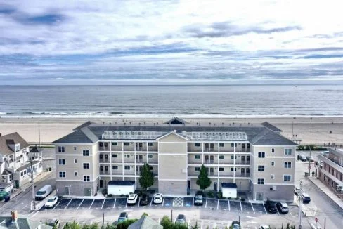 An aerial view of an apartment complex near the beach.