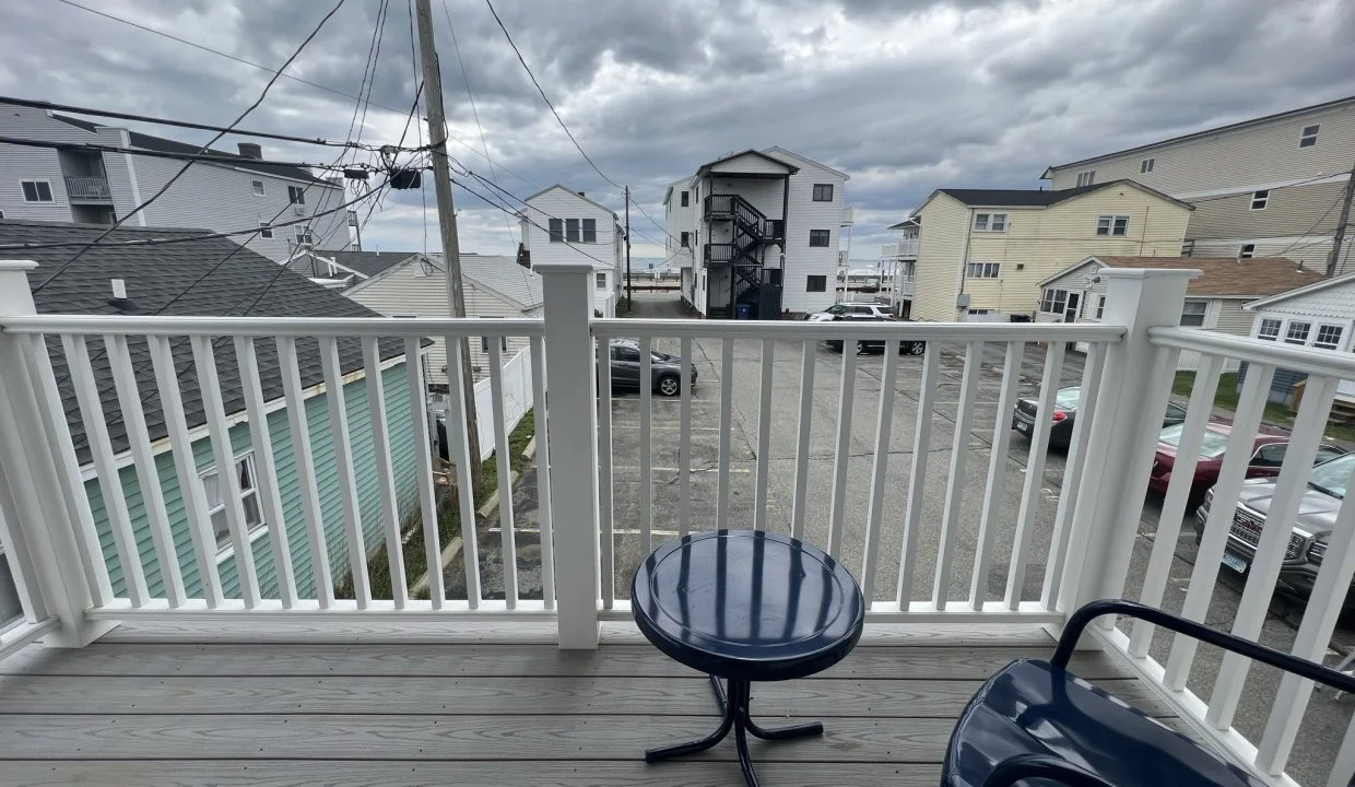 a couple of chairs sitting on top of a wooden deck.