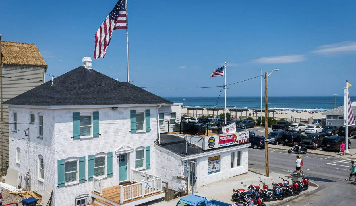 a group of motorcycles parked in front of a white building.