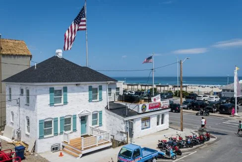 a group of motorcycles parked in front of a white building.