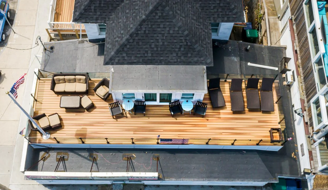 an aerial view of a house with patio furniture.