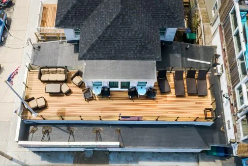 an aerial view of a house with patio furniture.