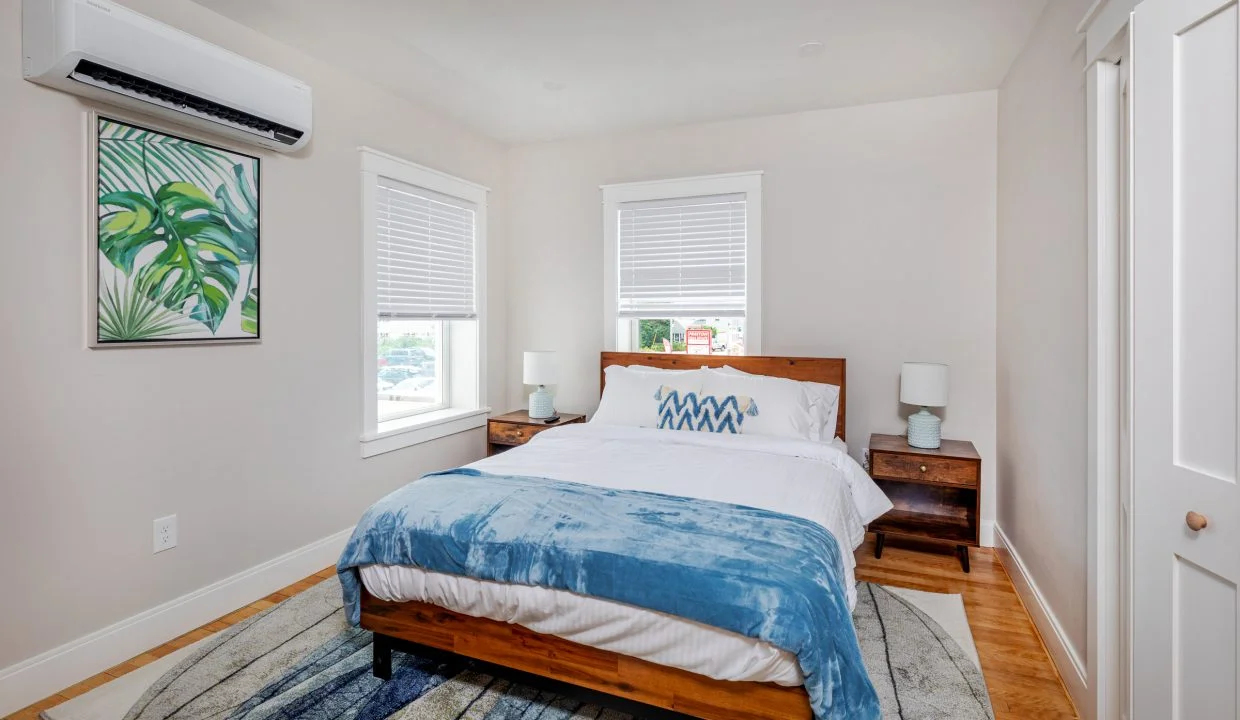 a bed sitting in a bedroom next to a window.