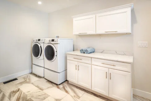 a washer and dryer in a white laundry room.