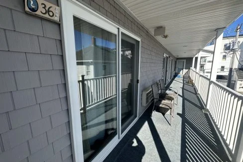 a balcony with chairs and a table on it.