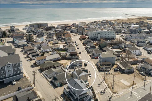 a bird's eye view of a neighborhood by the beach.