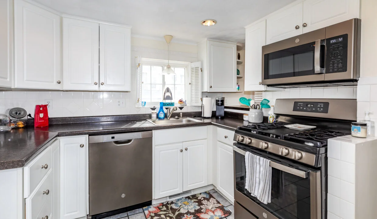 a kitchen with stainless steel appliances and white cabinets.