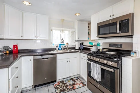 a kitchen with stainless steel appliances and white cabinets.