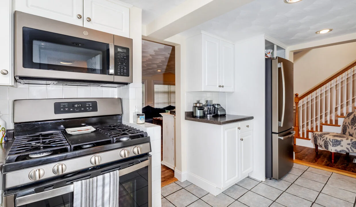 a kitchen with stainless steel appliances and white cabinets.