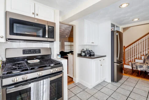 a kitchen with stainless steel appliances and white cabinets.