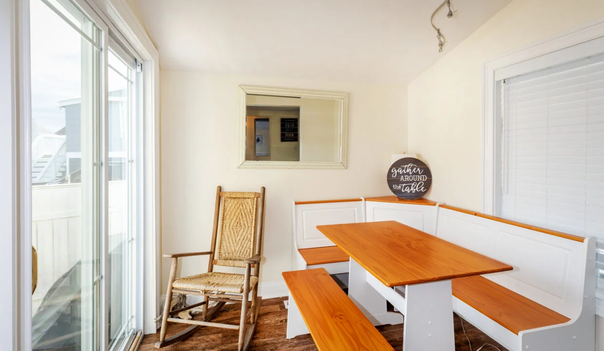 a room with a bench, table and a chair.