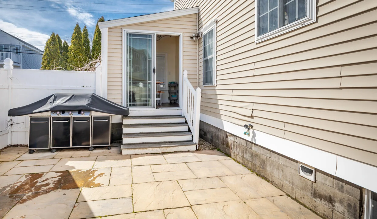 a house with a patio and steps leading to the front door.