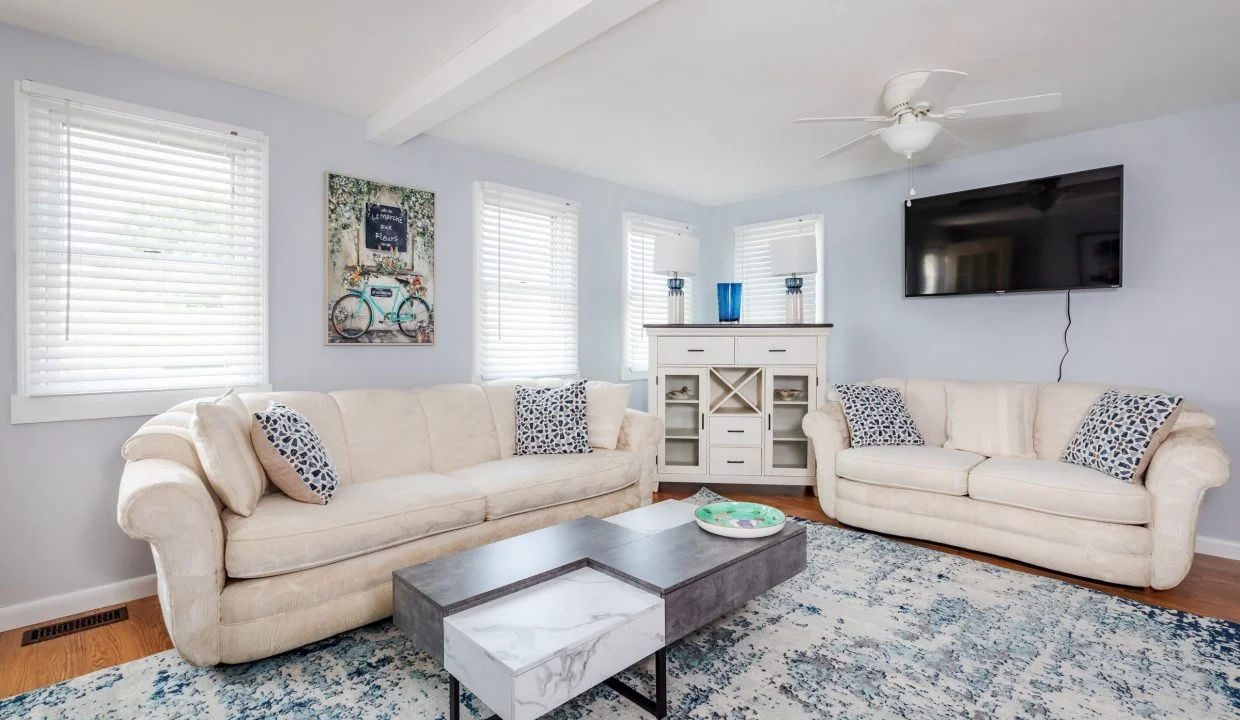 a living room filled with furniture and a flat screen tv.