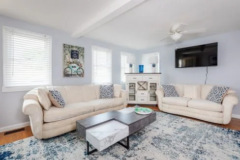 a living room filled with furniture and a flat screen tv.