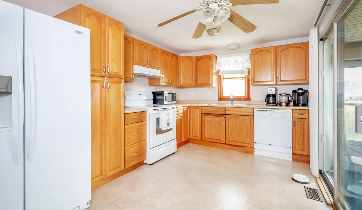 a white refrigerator freezer sitting inside of a kitchen.