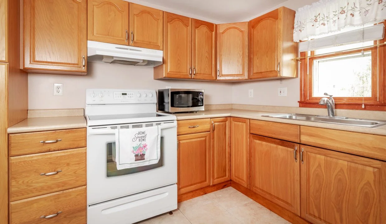 a kitchen with wooden cabinets and white appliances.