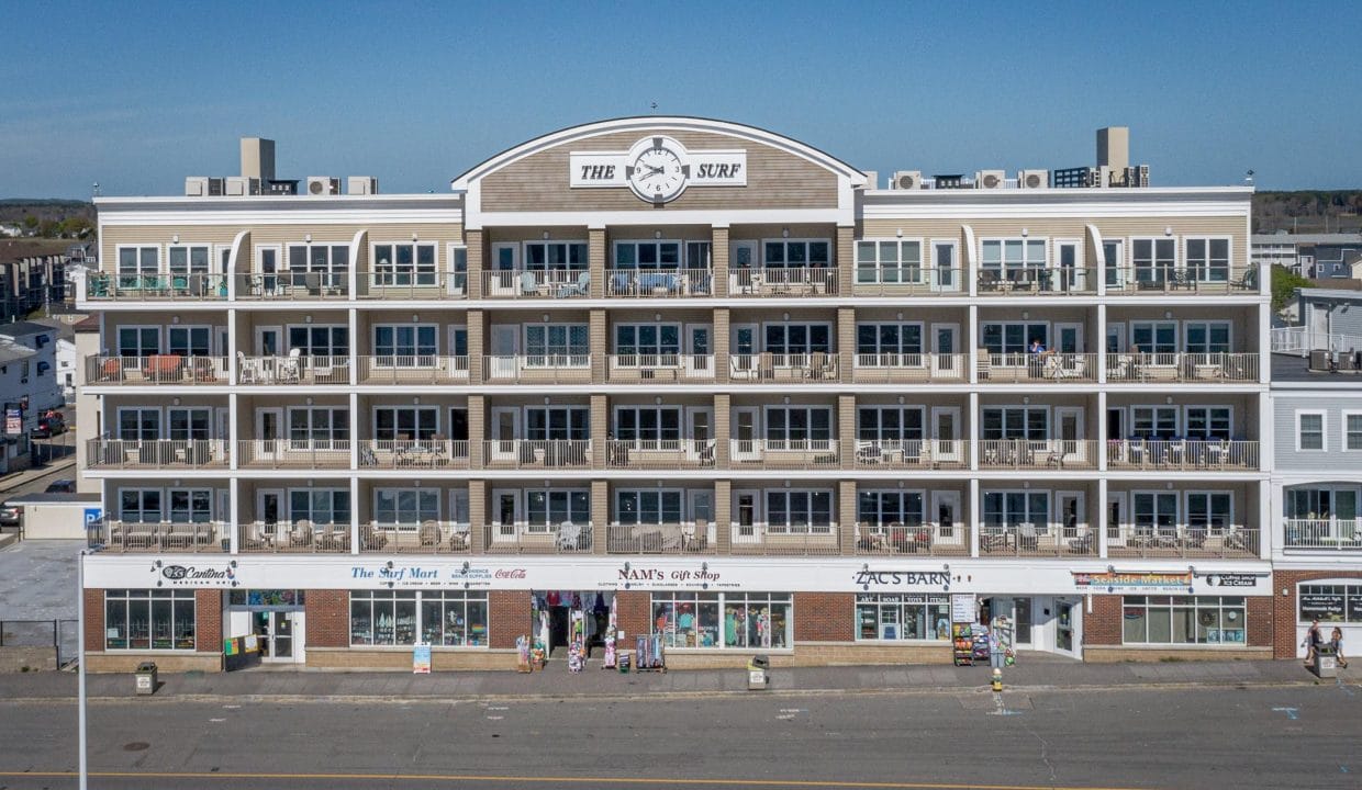 Four-story beachfront building with balconies, labeled 