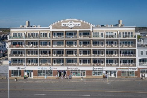 Four-story beachfront building with balconies, labeled 